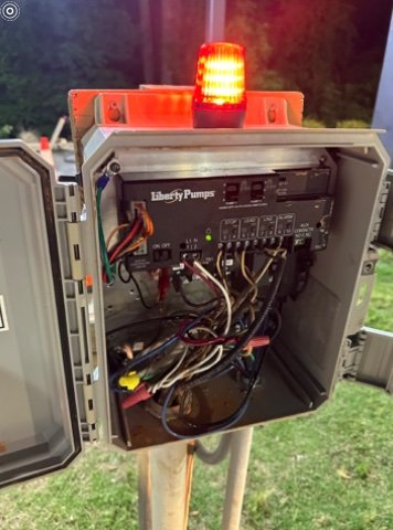 Septic pump alarm — red light actively glowing at night