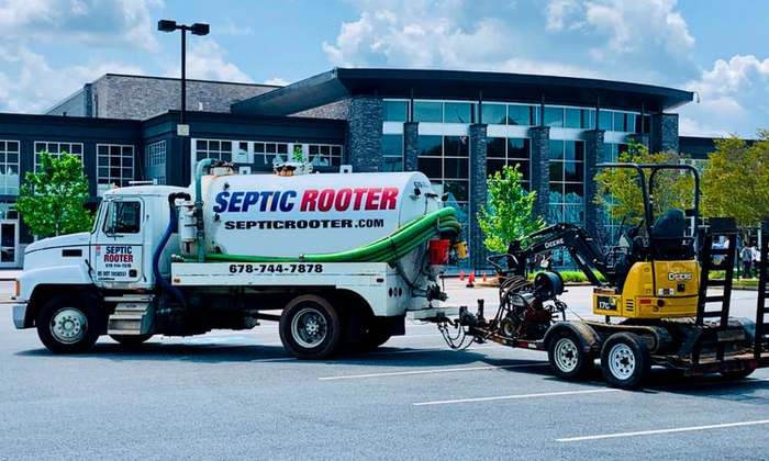 SepticRooter™ service truck and excavator on a septic repair job in Dacula, Georgia